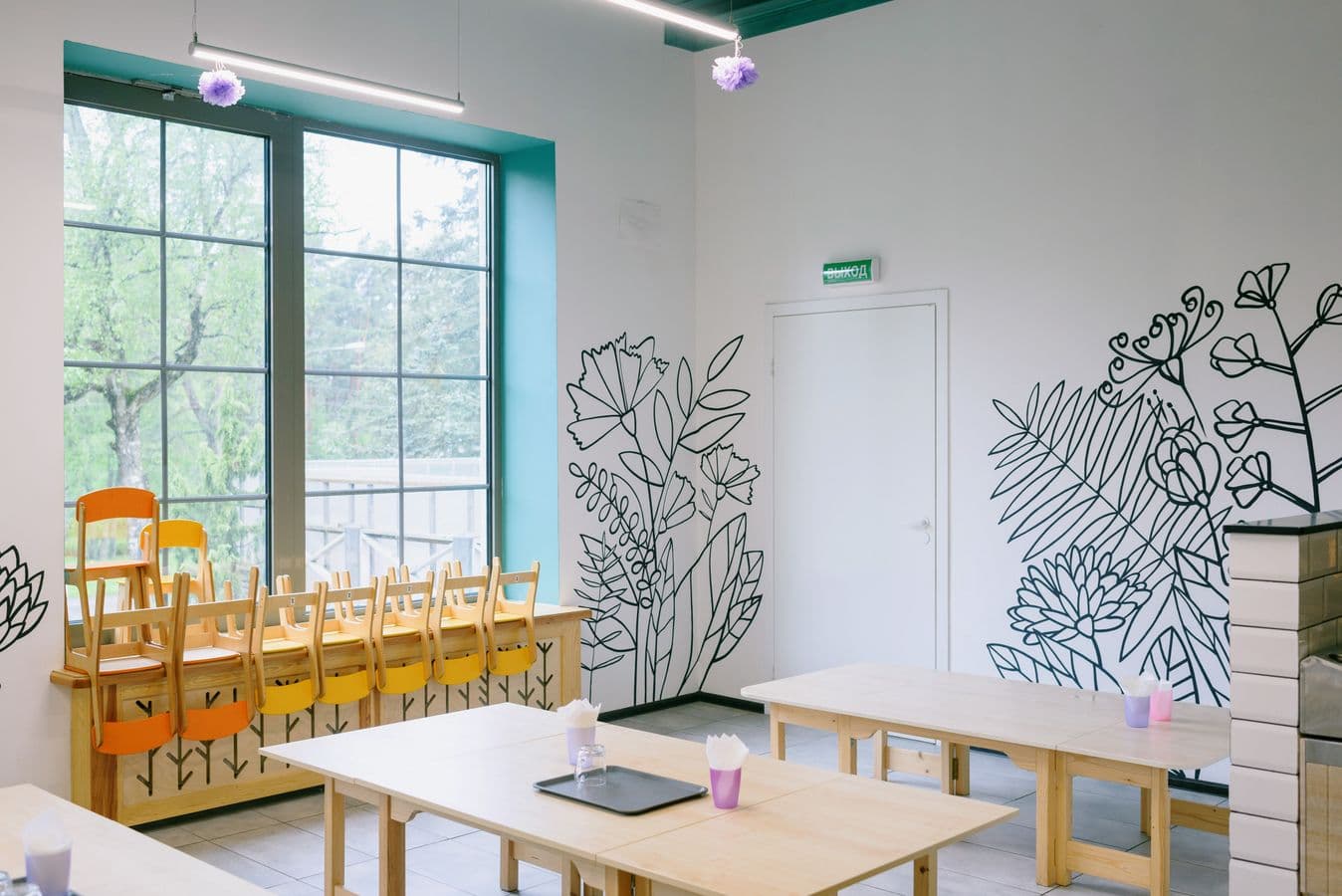 Empty early education classroom with child-sized tables and chairs